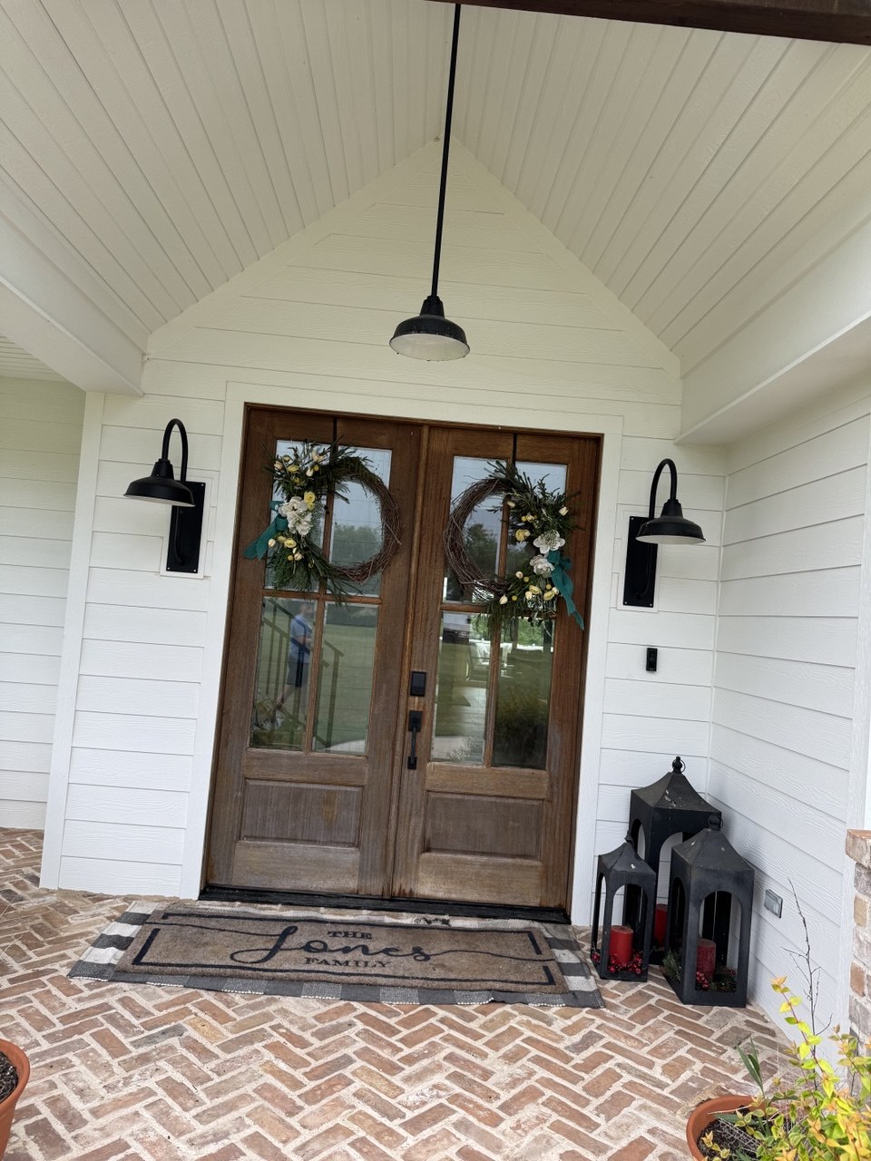 Finished front entry with clean siding and wood doors