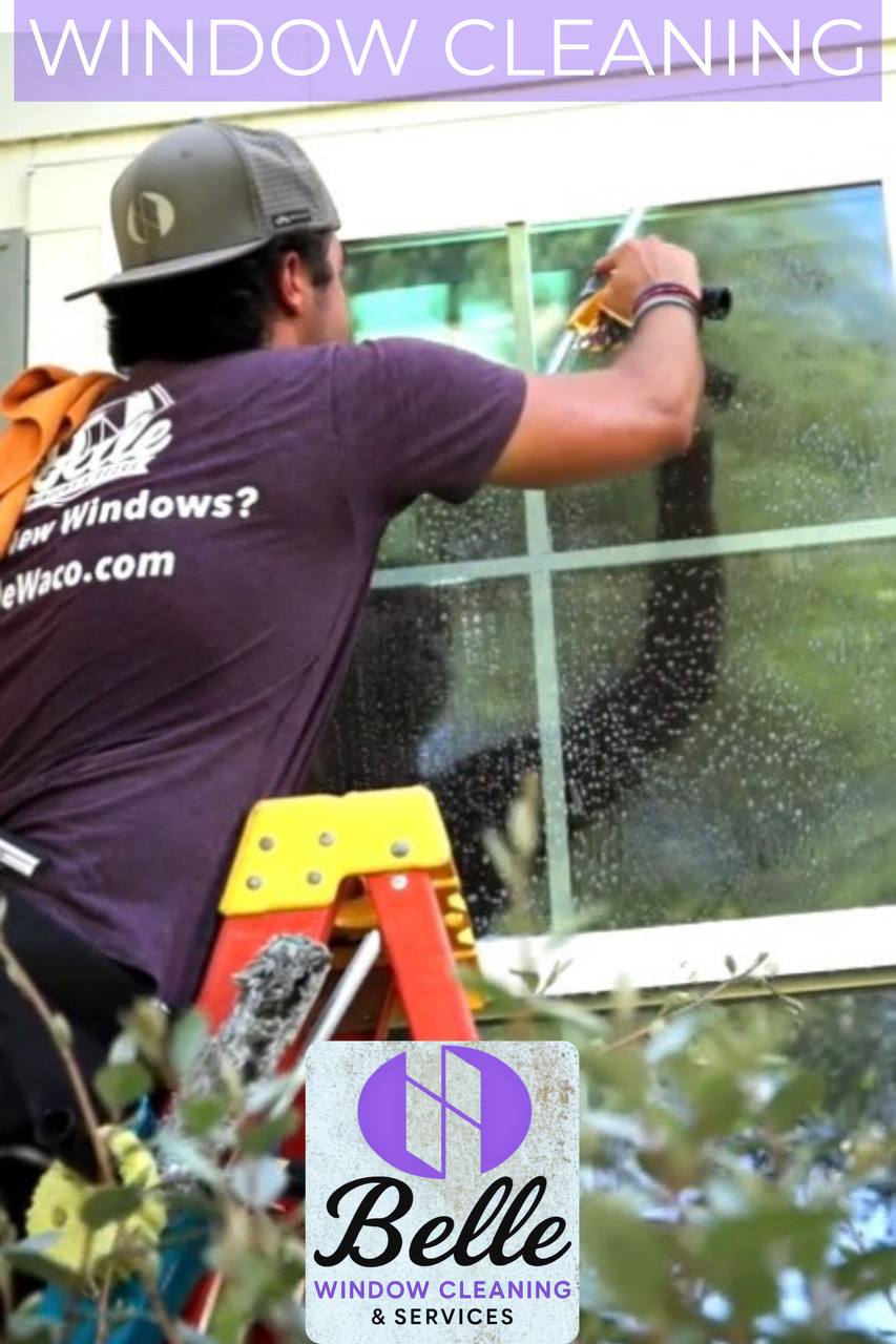 Belle Window Cleaning team member working on exterior glass at a residential property